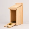 Natural wood bluebird house with front cleanout door open and mesh floor visible