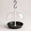 Empty black round seed tray beneath a clear dome for easy filling and cleaning