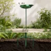 Multi-prong metal ground stake anchoring the bird bath pole in garden soil