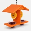Bright orange hanging oriole feeder with two jelly cups and two orange halves